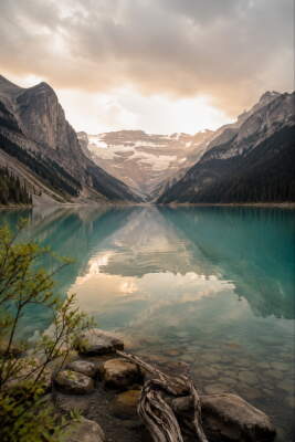 Turquoise Mountain Lake Beneath Soft Clouds