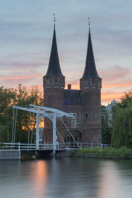 Historic Gatehouse by Calm Water at Sunset