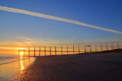Zonsopkomst bij de steiger van het Waddenveer bij Kaap Noord op Texel